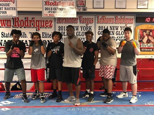A group of young men are posing for a picture in front of a sign that says rodriguez