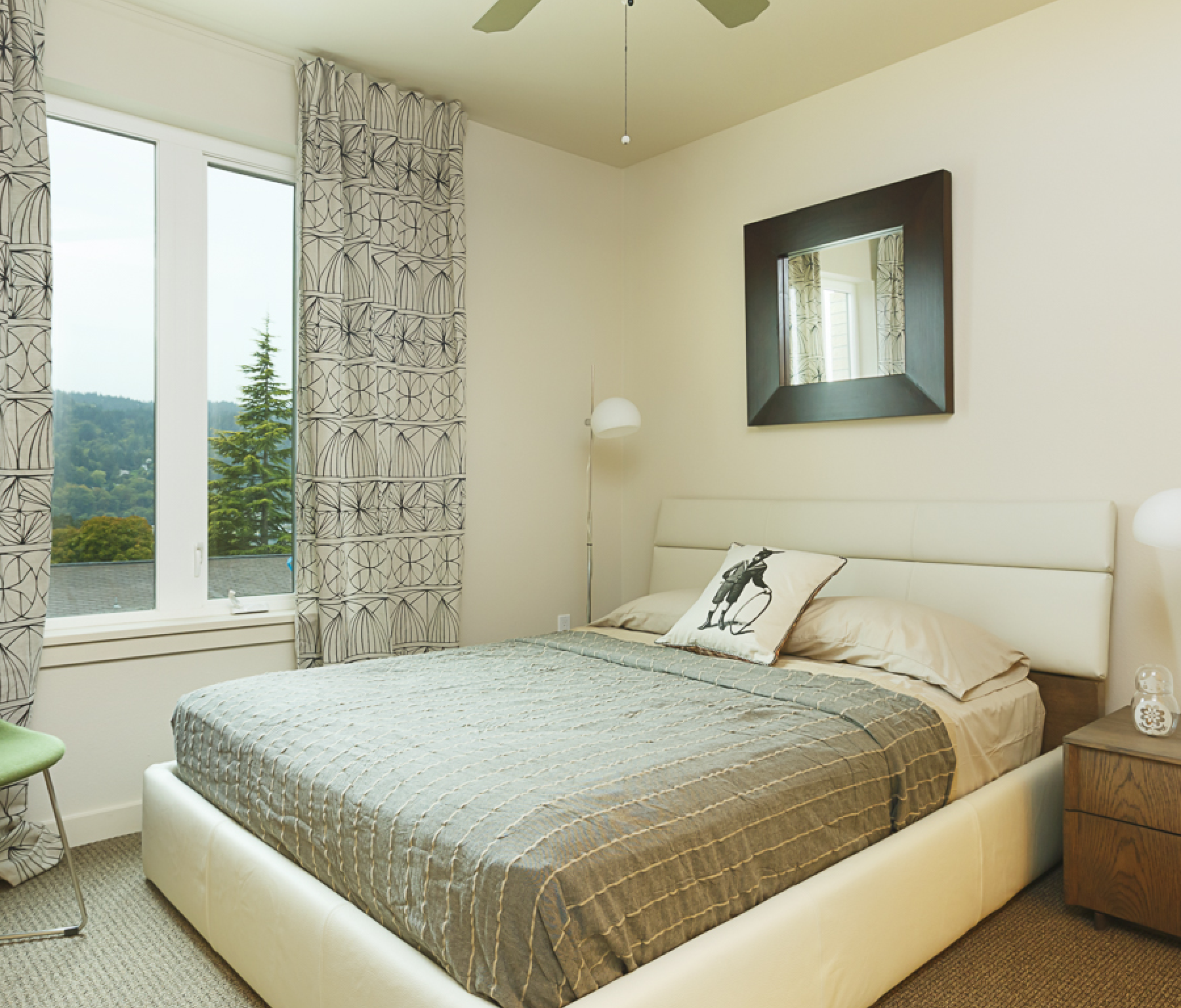 A bedroom with a large bed and a mirror on the wall