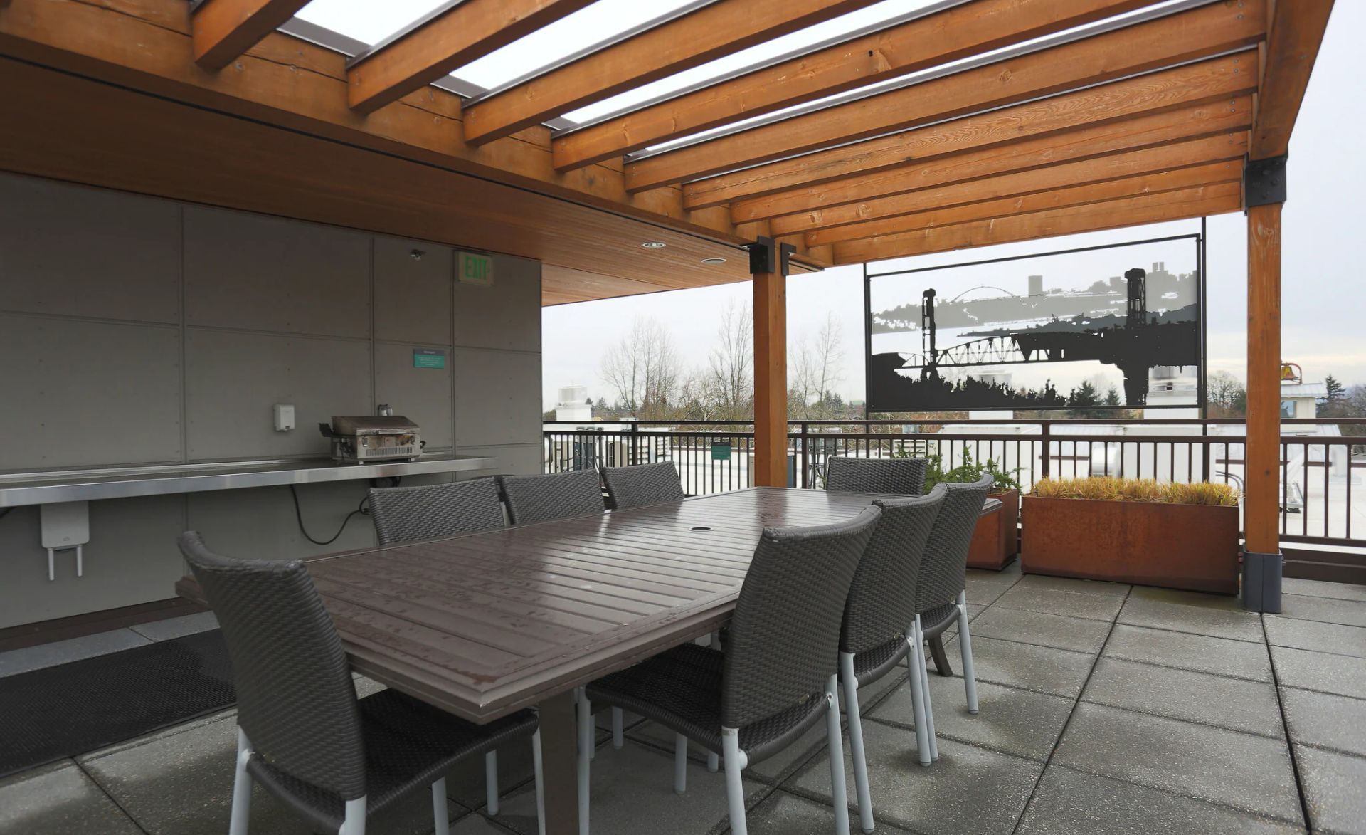 A patio with a table and chairs under a pergola