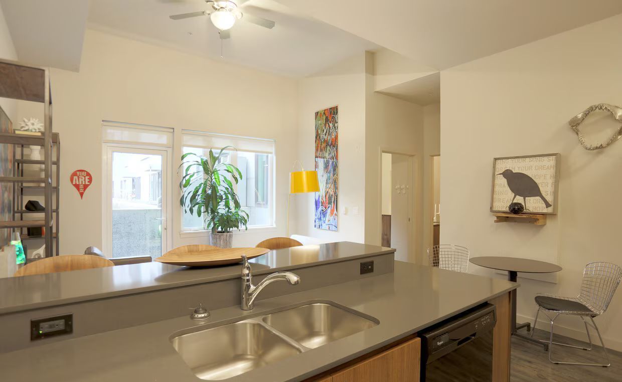 A kitchen with a sink and a ceiling fan.