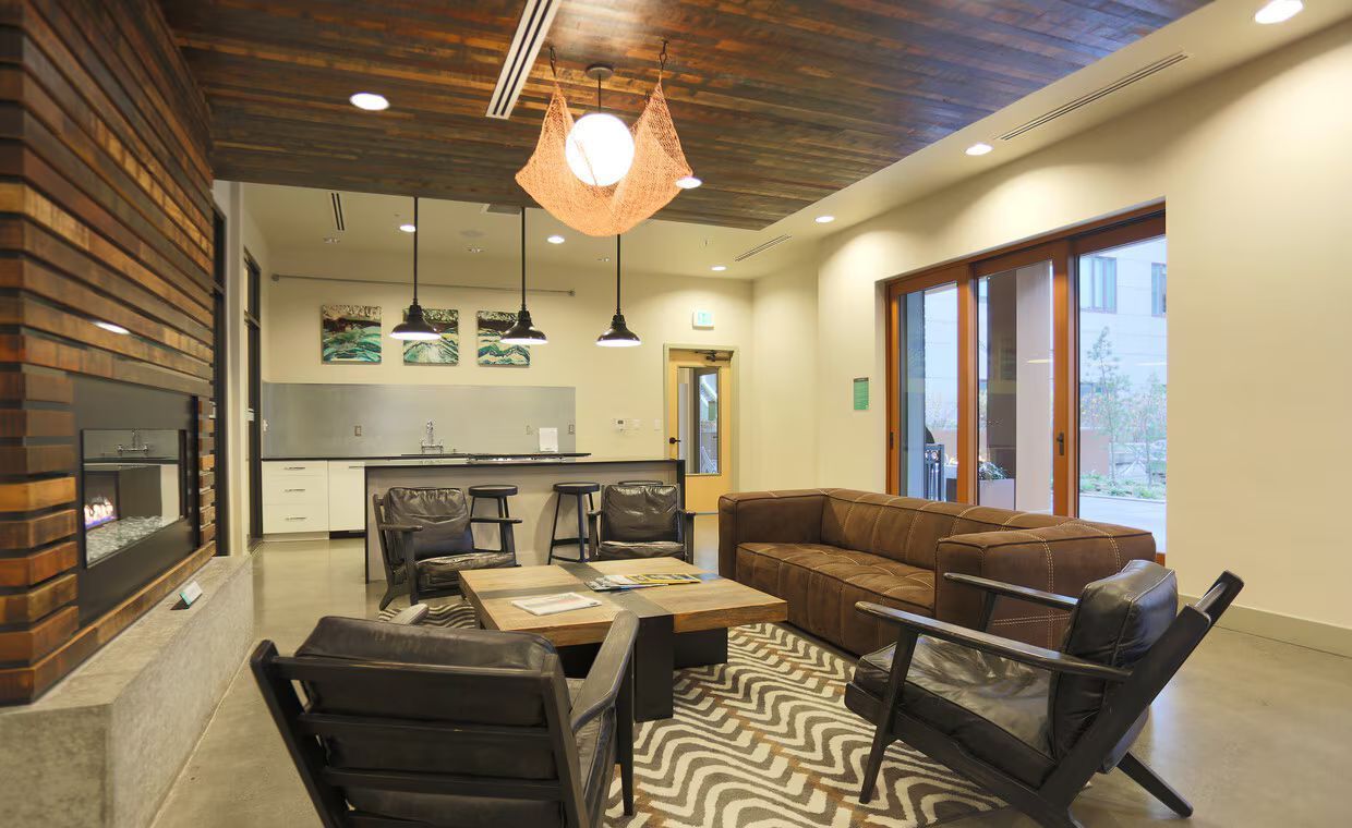 A living room with a couch and chairs and a fireplace