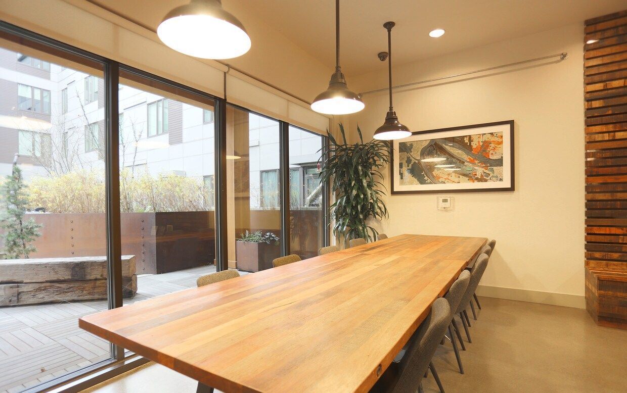 There is a long wooden table in the middle of the room.