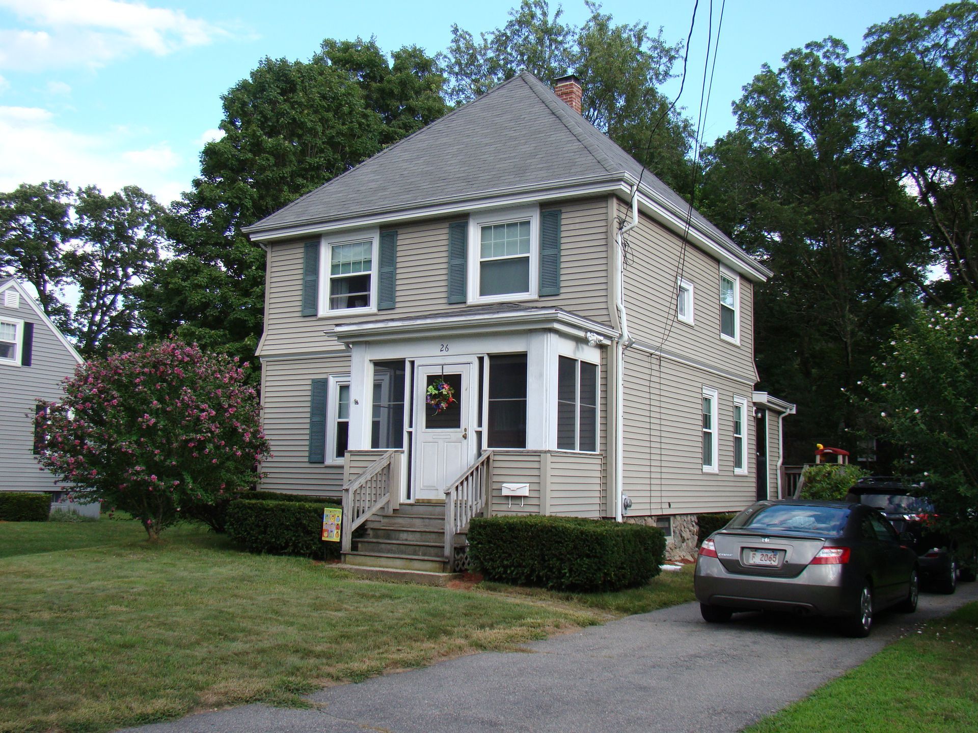 A house with a car parked in front of it