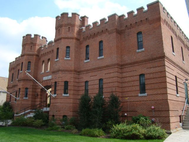 A large red brick building looks like a castle