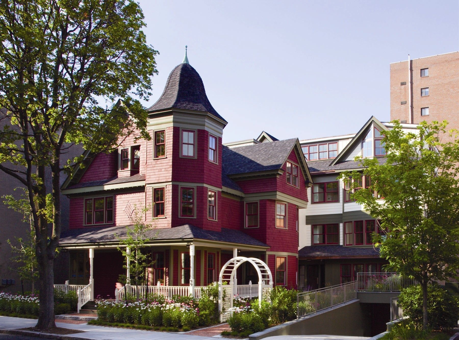 A large red brick house with a black roof