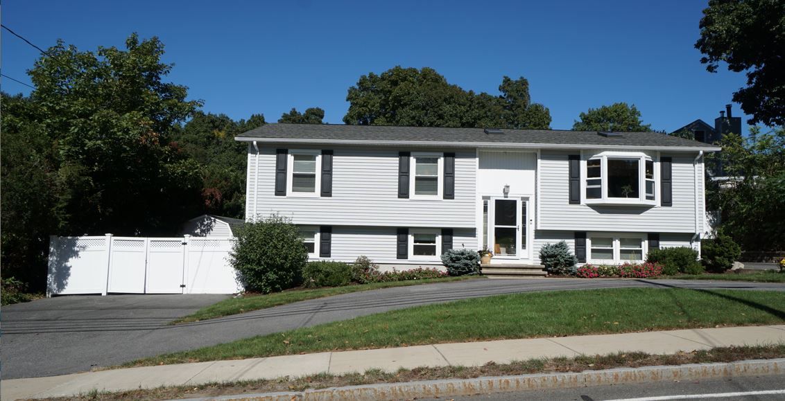A white house with a white fence in front of it