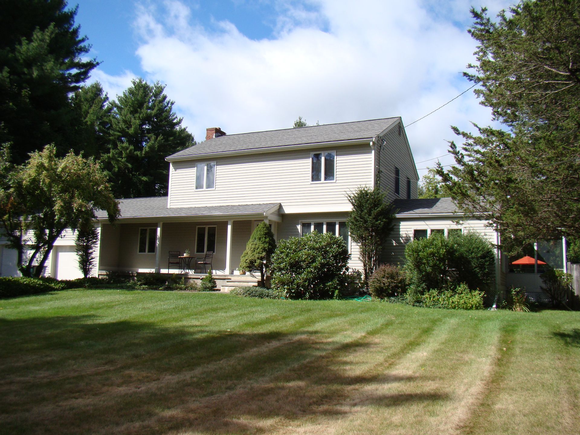 A house with a large lawn in front of it