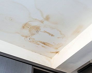 a ceiling with a lot of water stains on it .