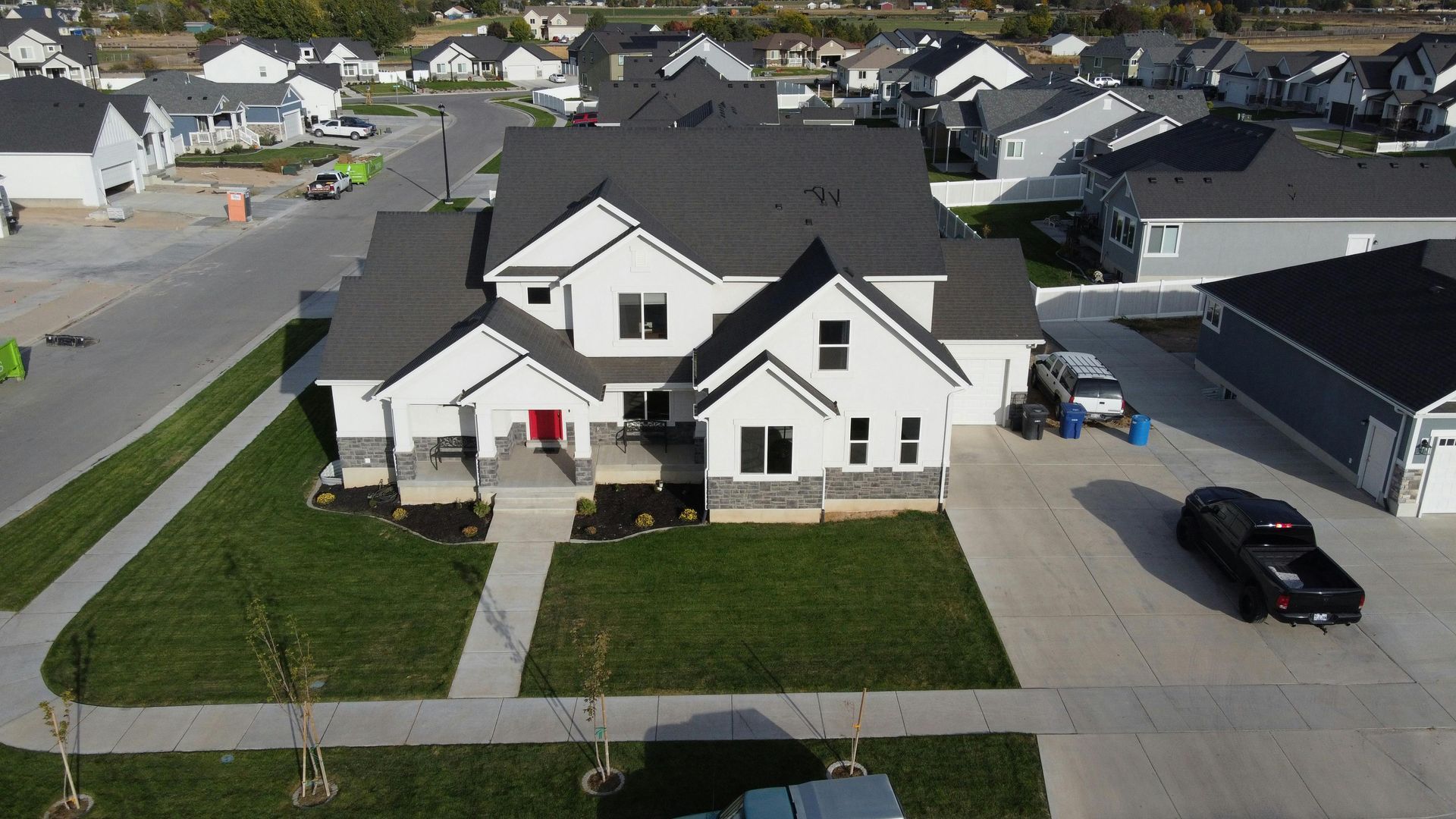 An aerial view of a house with a truck parked in front of it