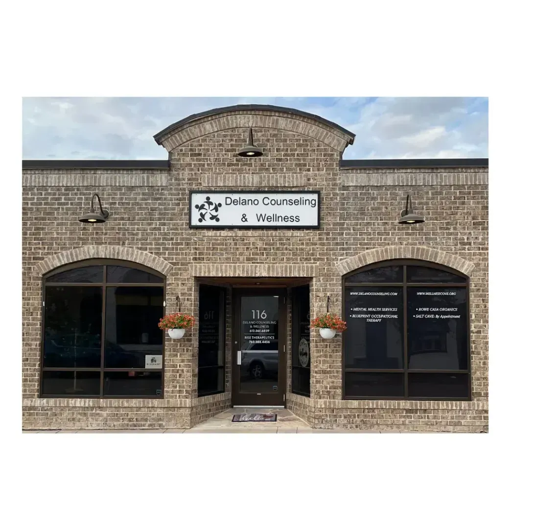 A tan brick storefront for Lone Star Storage & Works with arched windows and a central entrance under a decorative gable.