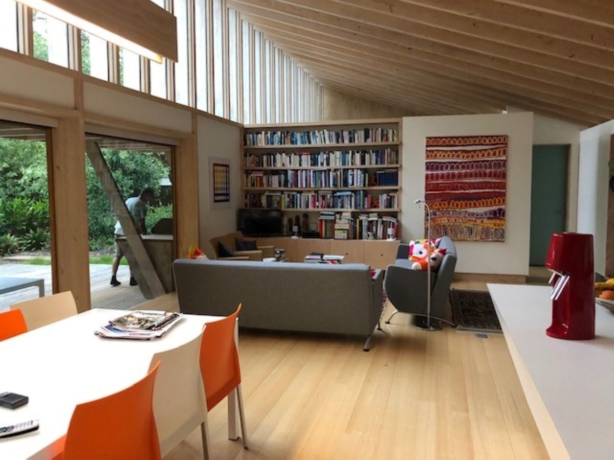 Living Space with A Bookshelf, Grey Sofa — On The Rise Builders in North Arm, QLD