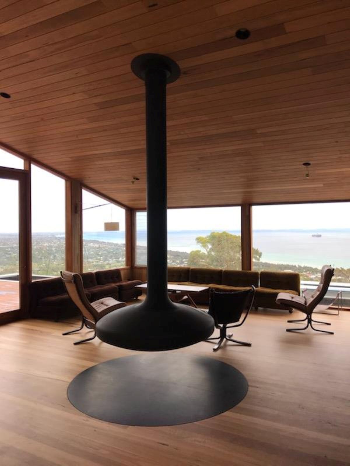 Black Hanging Fireplace in A Modern Living Room with A View of The Ocean — On The Rise Builders in North Arm, QLD