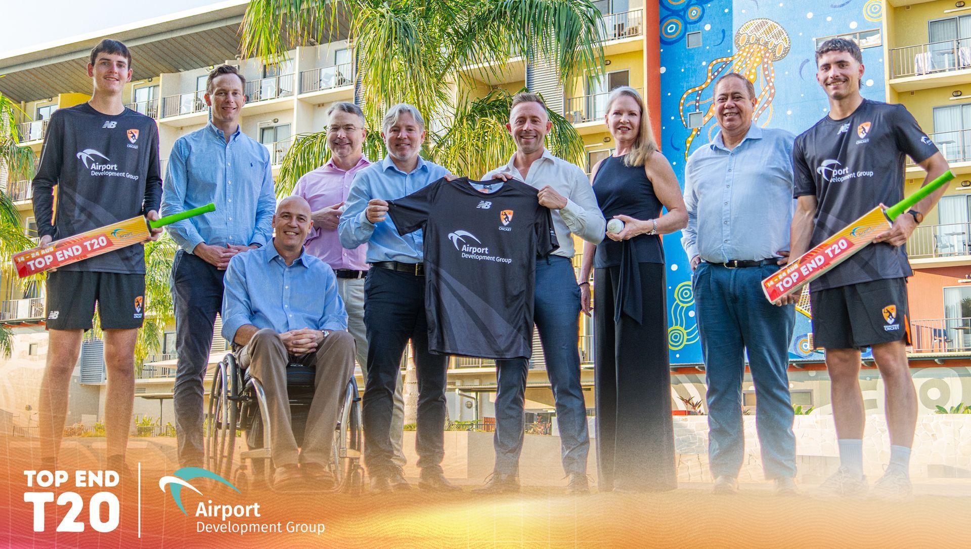 A group of people standing with a sponsorship jersey