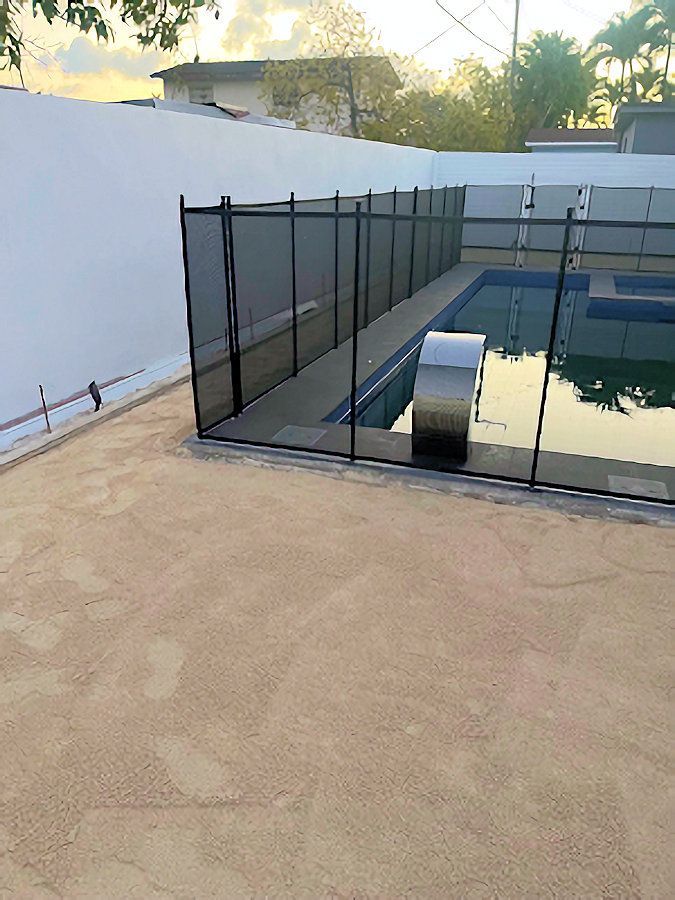 A large swimming pool with a fence around it.