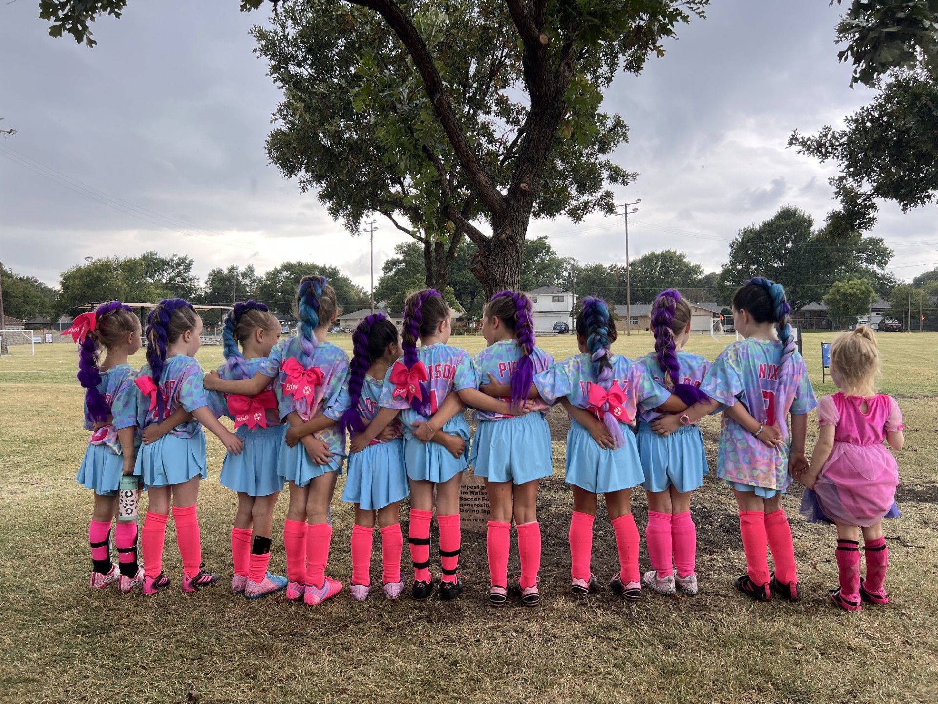 Basketball about to go through a hoop.