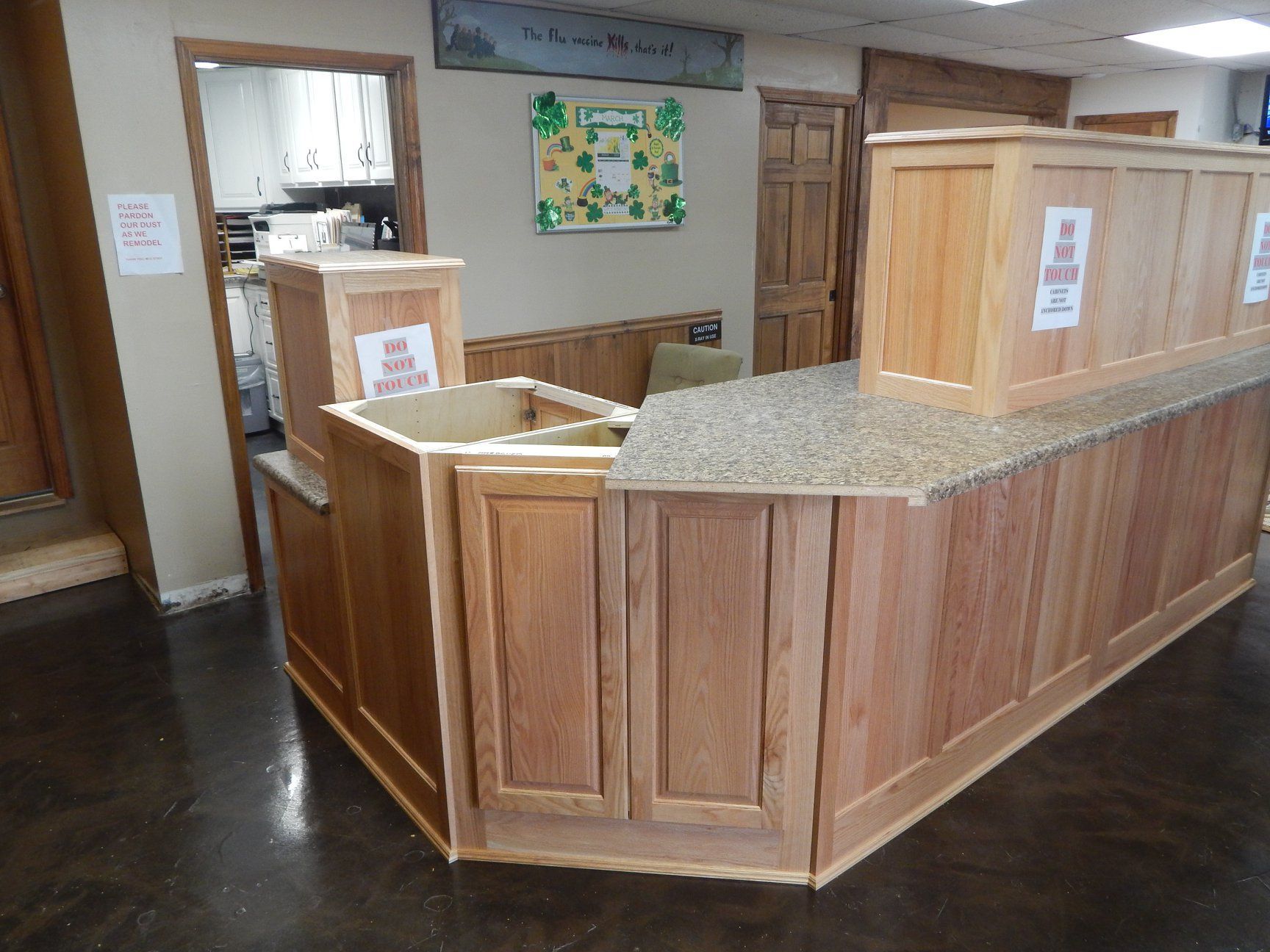 A wooden counter with a granite counter top in a room.