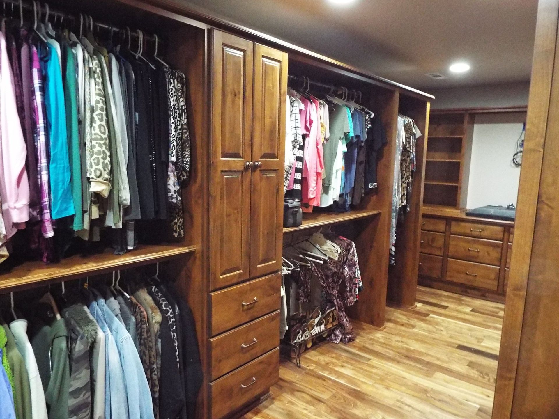 A walk in closet filled with lots of clothes