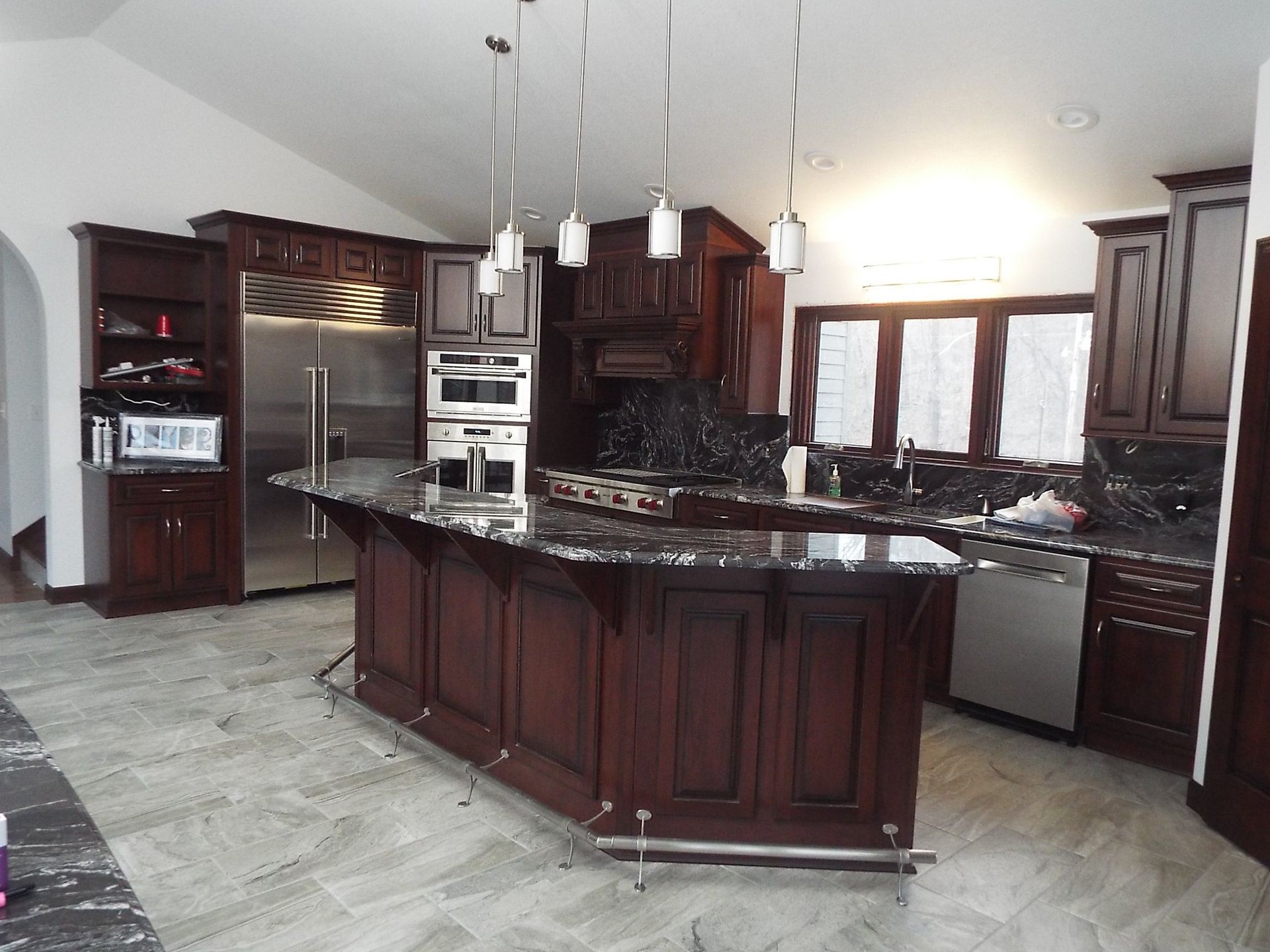 A kitchen with a large island and stainless steel appliances