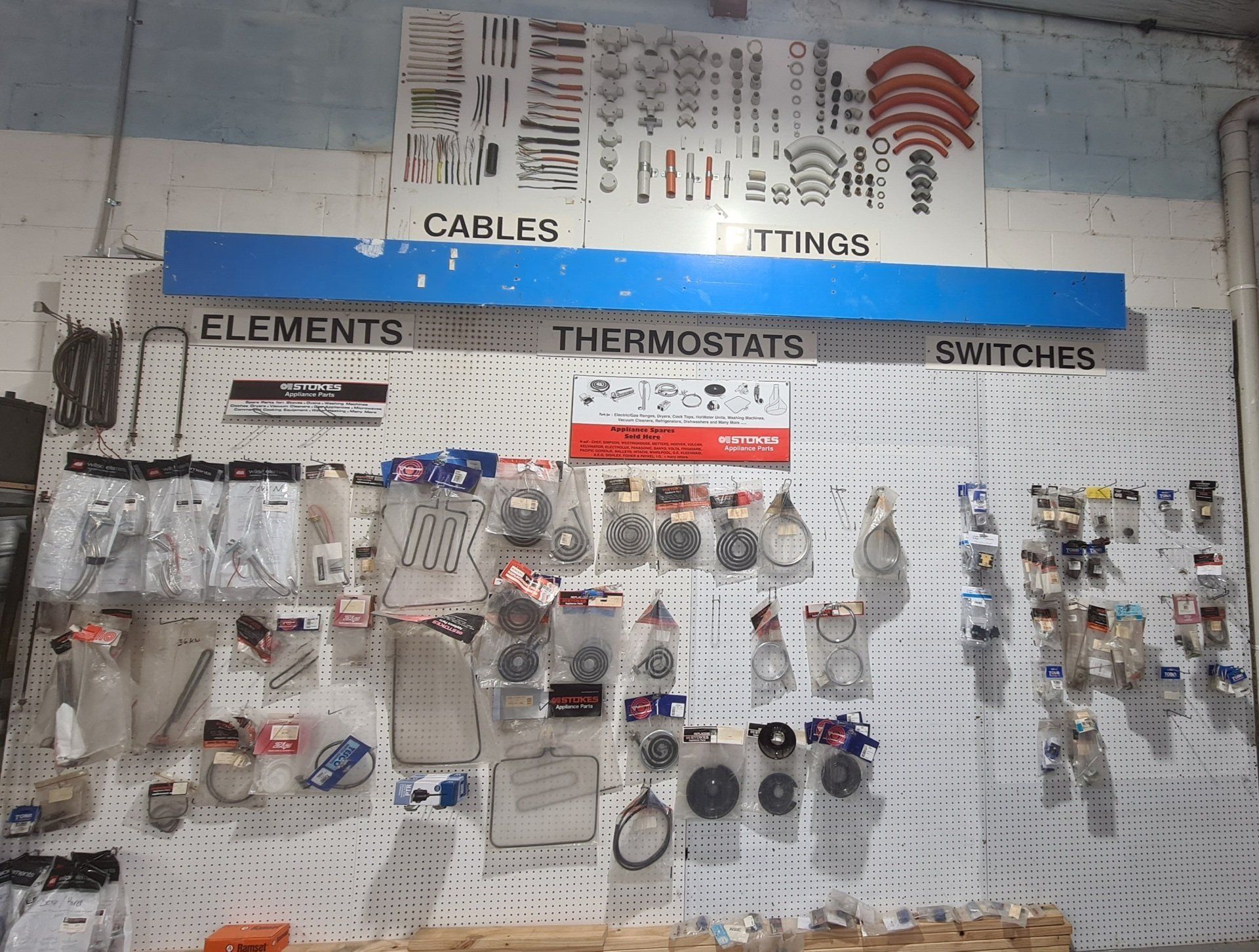 A wall with electrical parts and supplies on it.