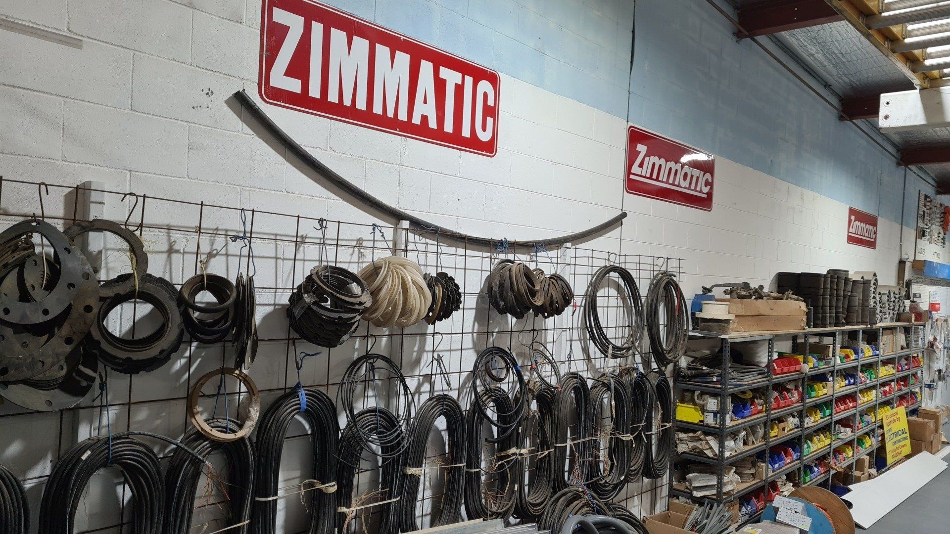 A warehouse filled with lots of electrical parts and a sign that says zimmatic.