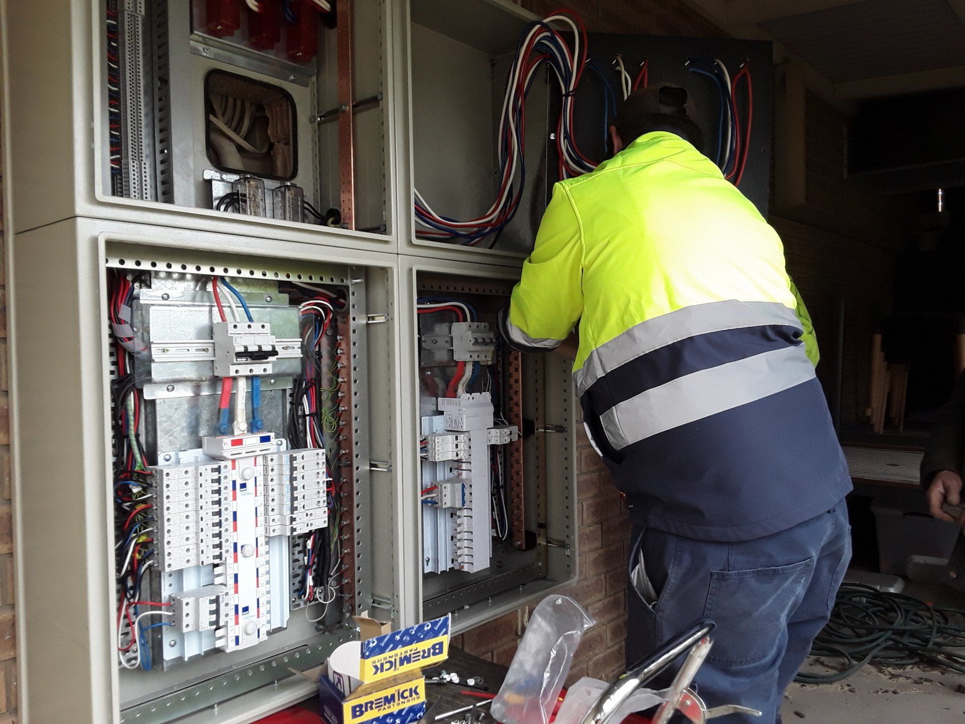 A man working on an electrical box.