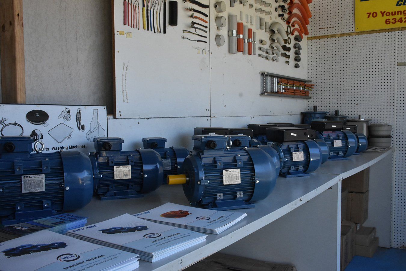 A bunch of motors lined up on a table.