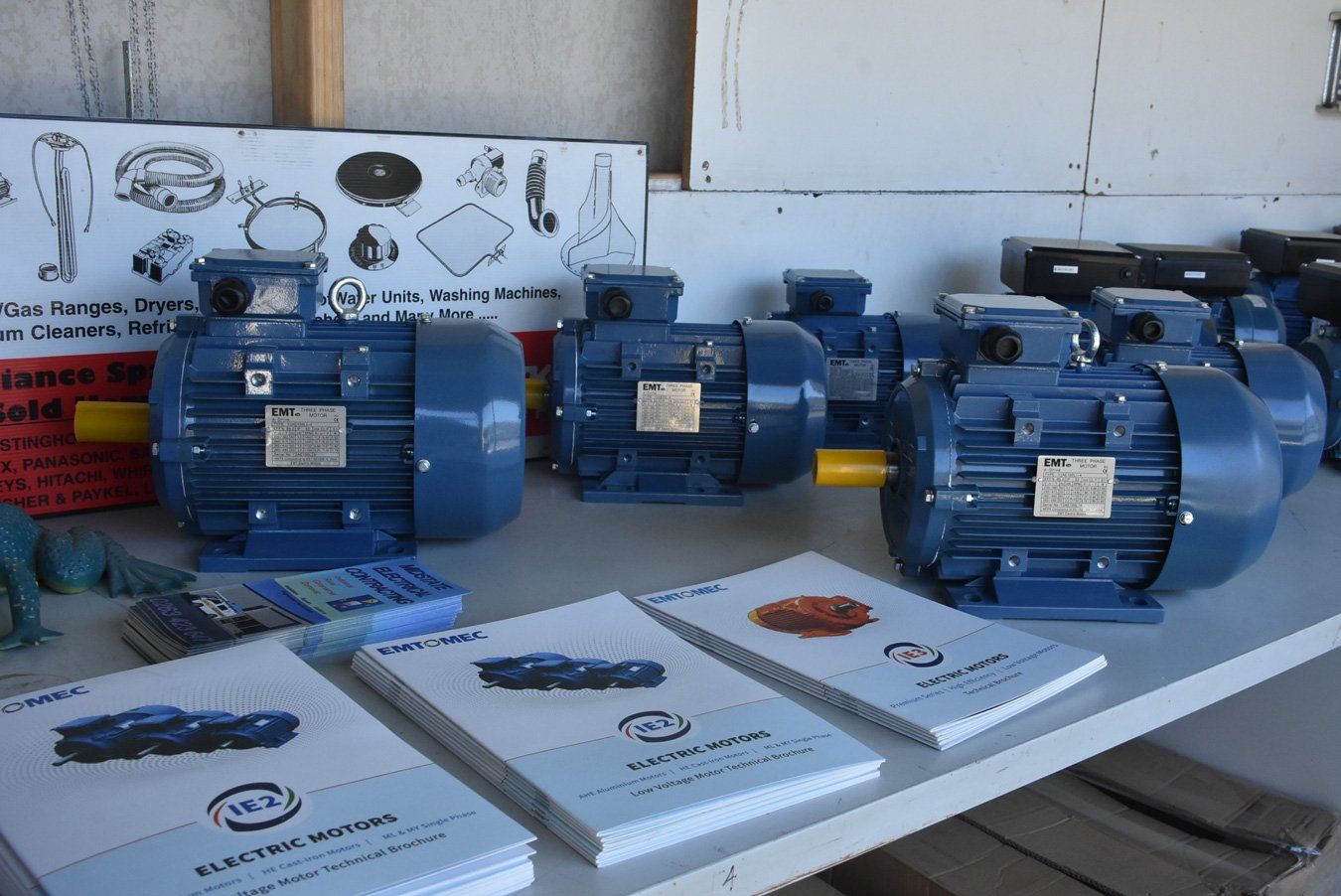 A row of blue electric motors sitting on top of a table.