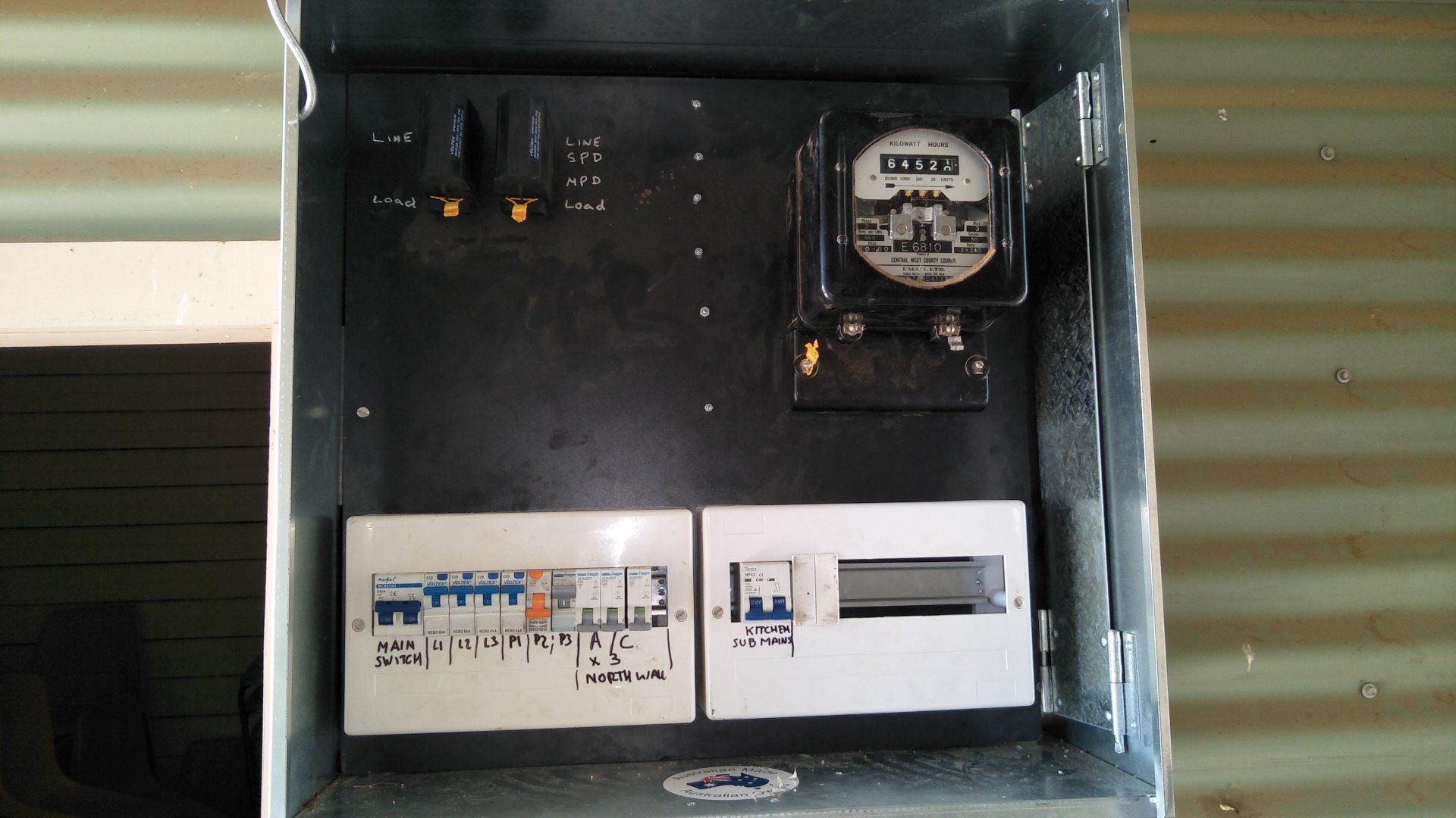 A black box with an electrical meter inside.