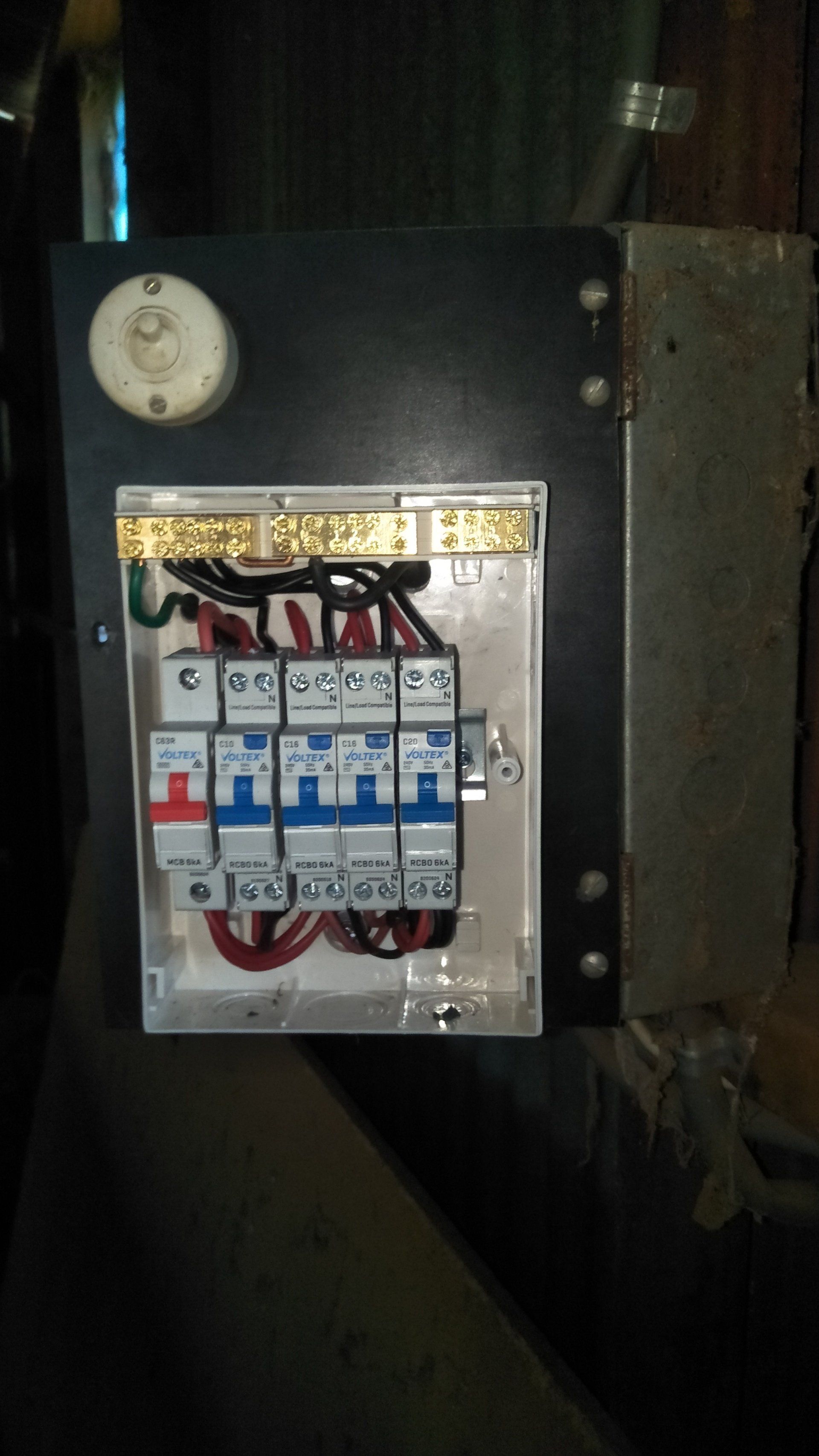 A close up of a electrical box on a wall.