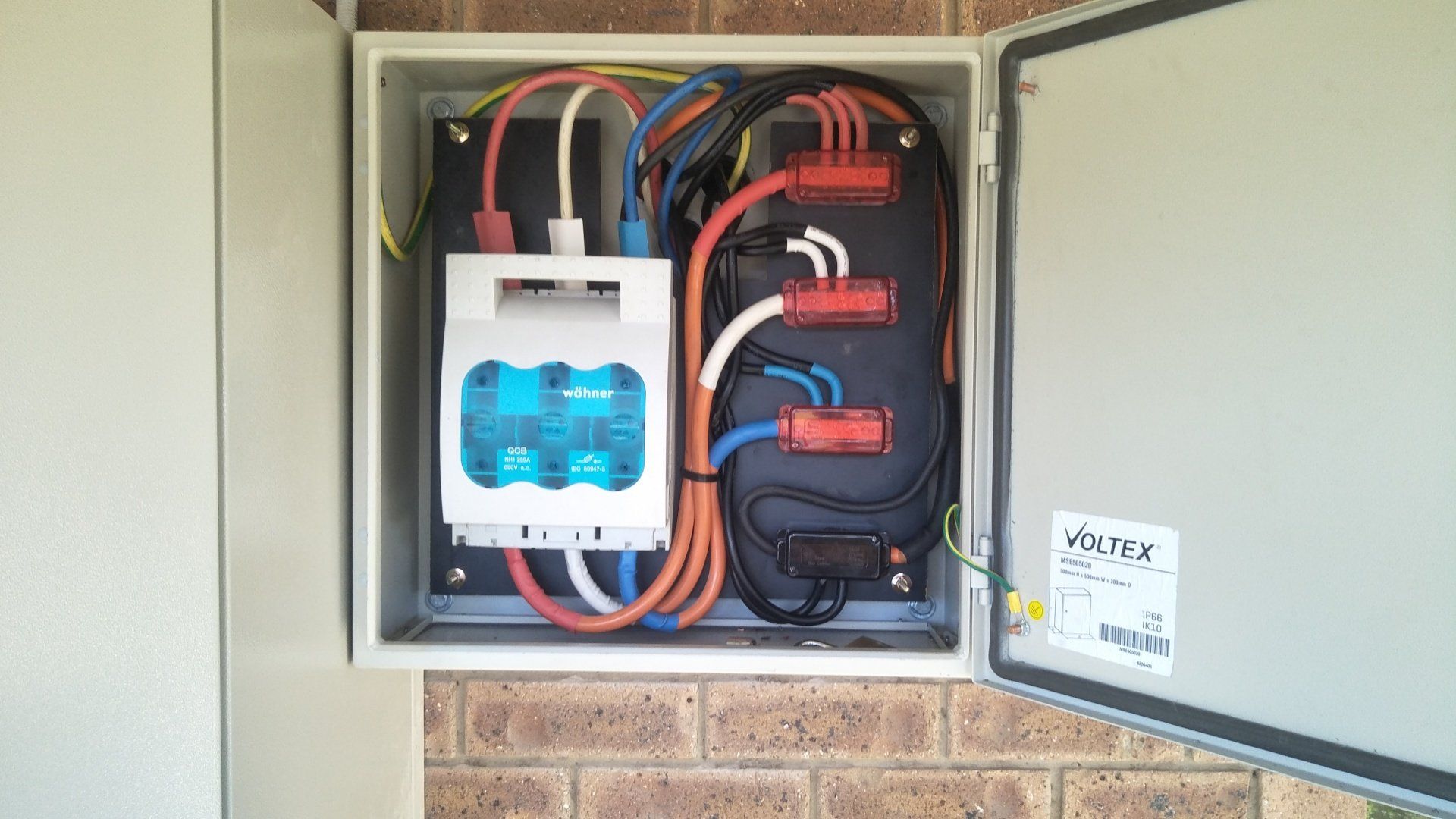 A close up of an electrical box on a wall.