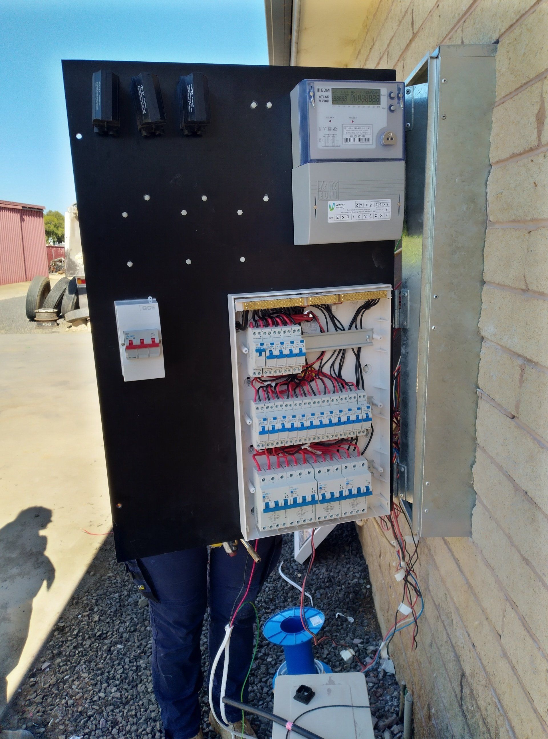 Electrical wires on a black board.