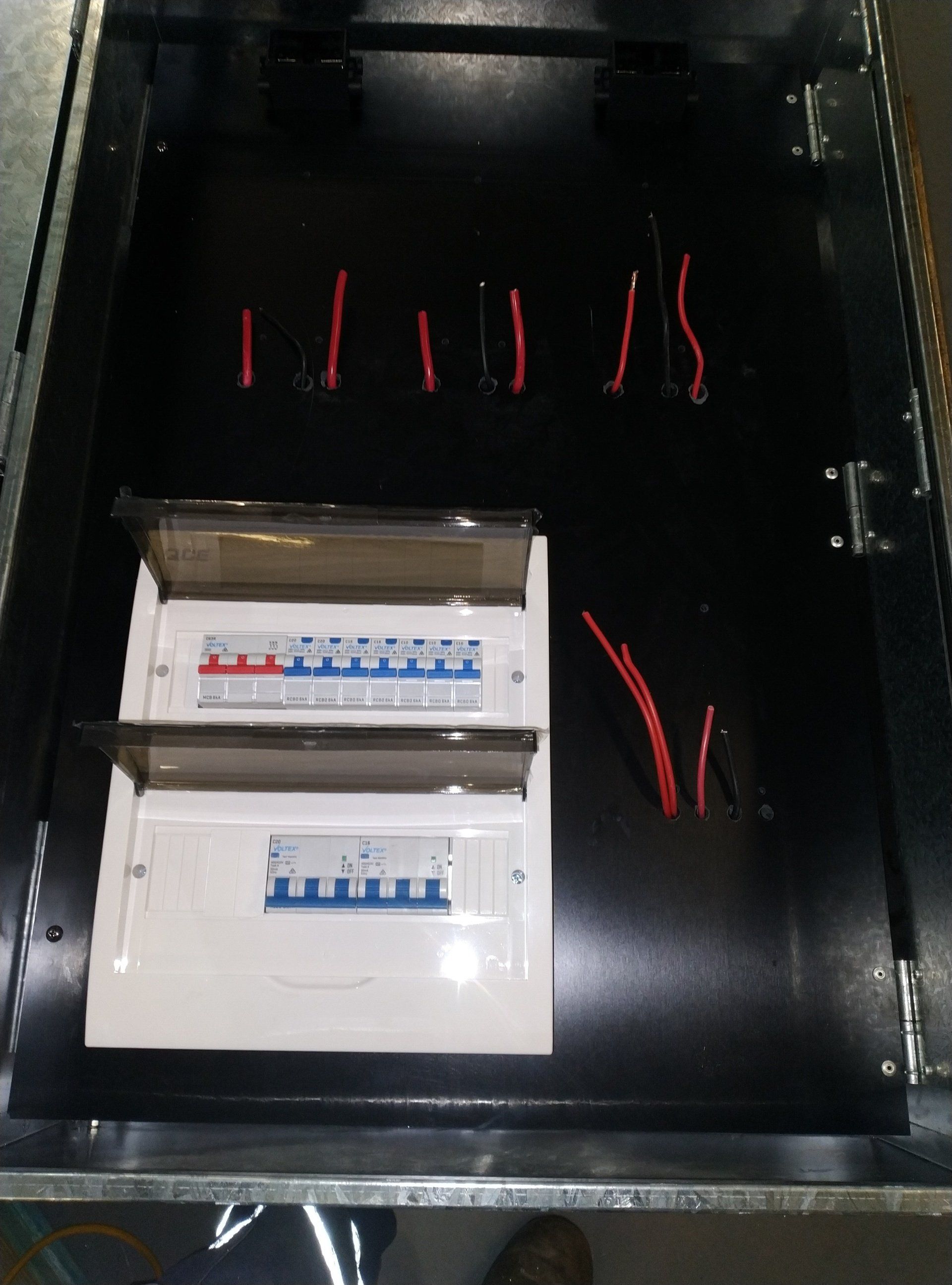 A black box with two electrical boxes inside of it.