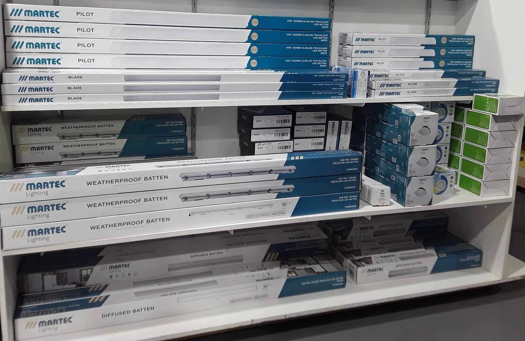 a shelf filled with boxes of electrical equipment