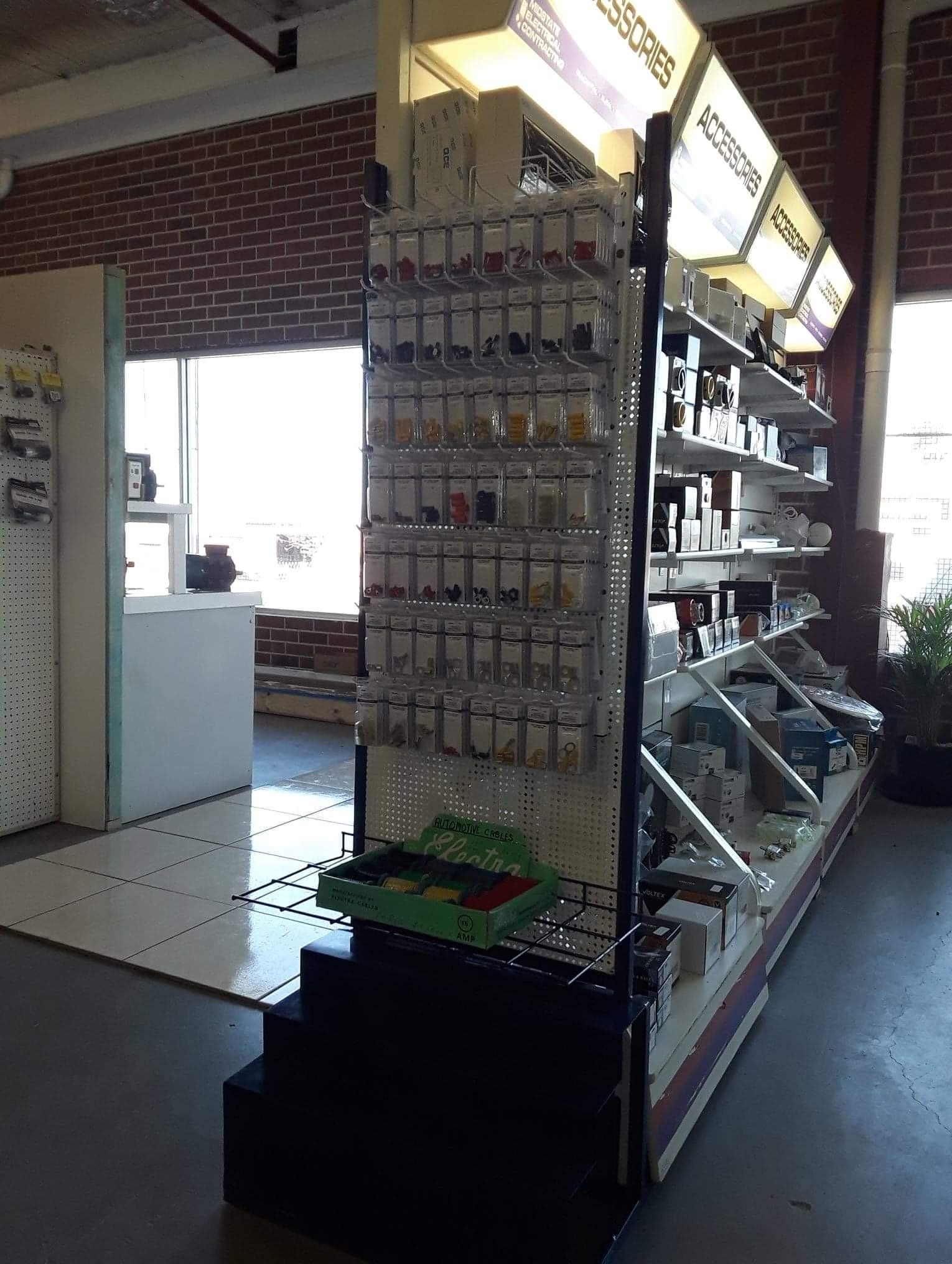 A store filled with lots of shelves and electrical supplies. 