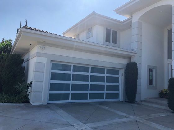 A large white house with a large garage door