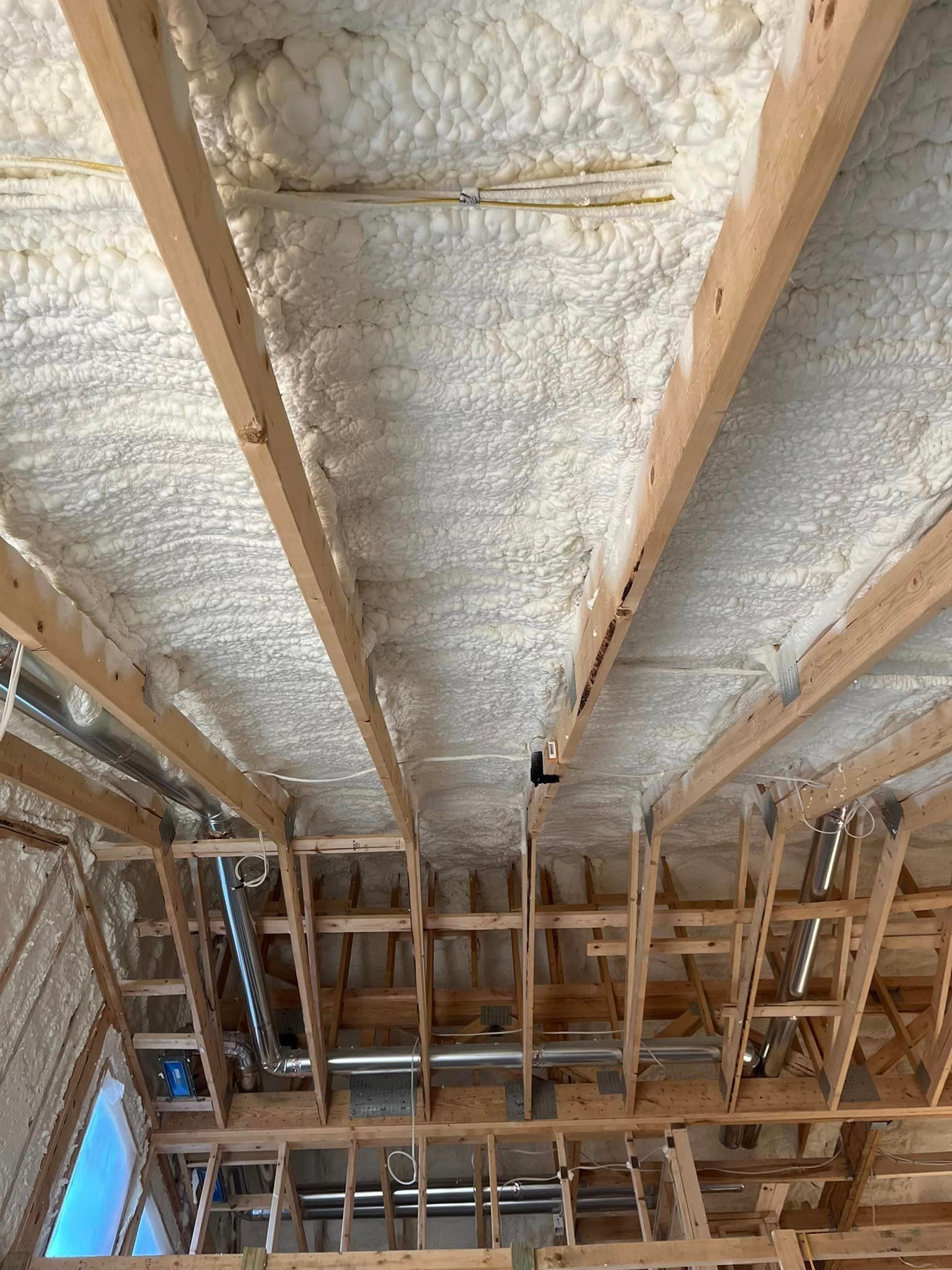 The ceiling of a building under construction is covered in foam.