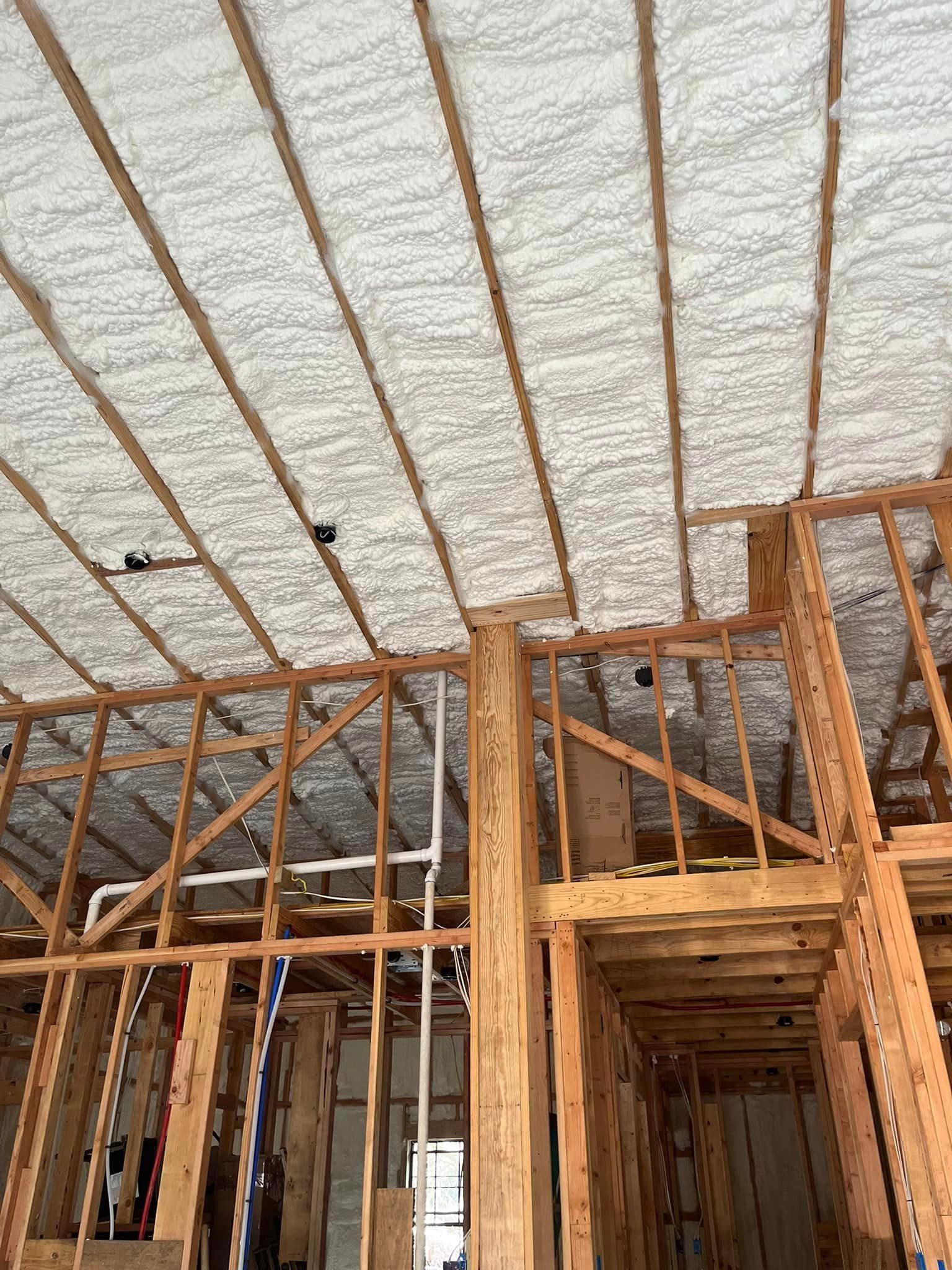 A house is being built and the ceiling is insulated with spray foam.
