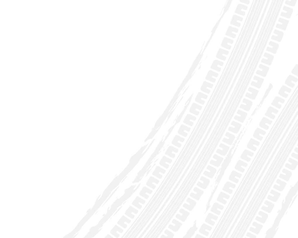 Two white tire tracks diagonally across a white background. | Doran-King Garage Inc