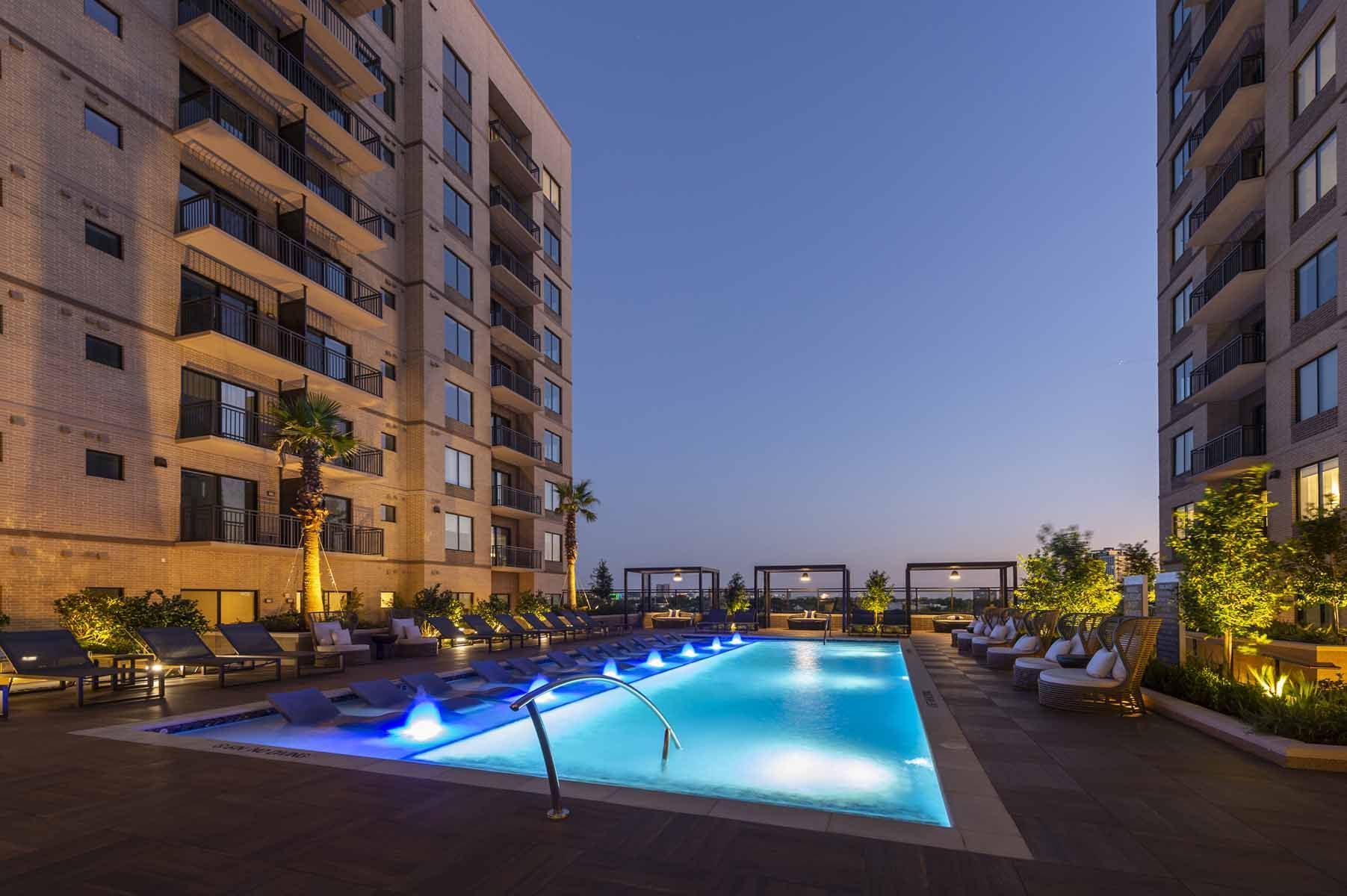 There is a large swimming pool in the middle of a building.