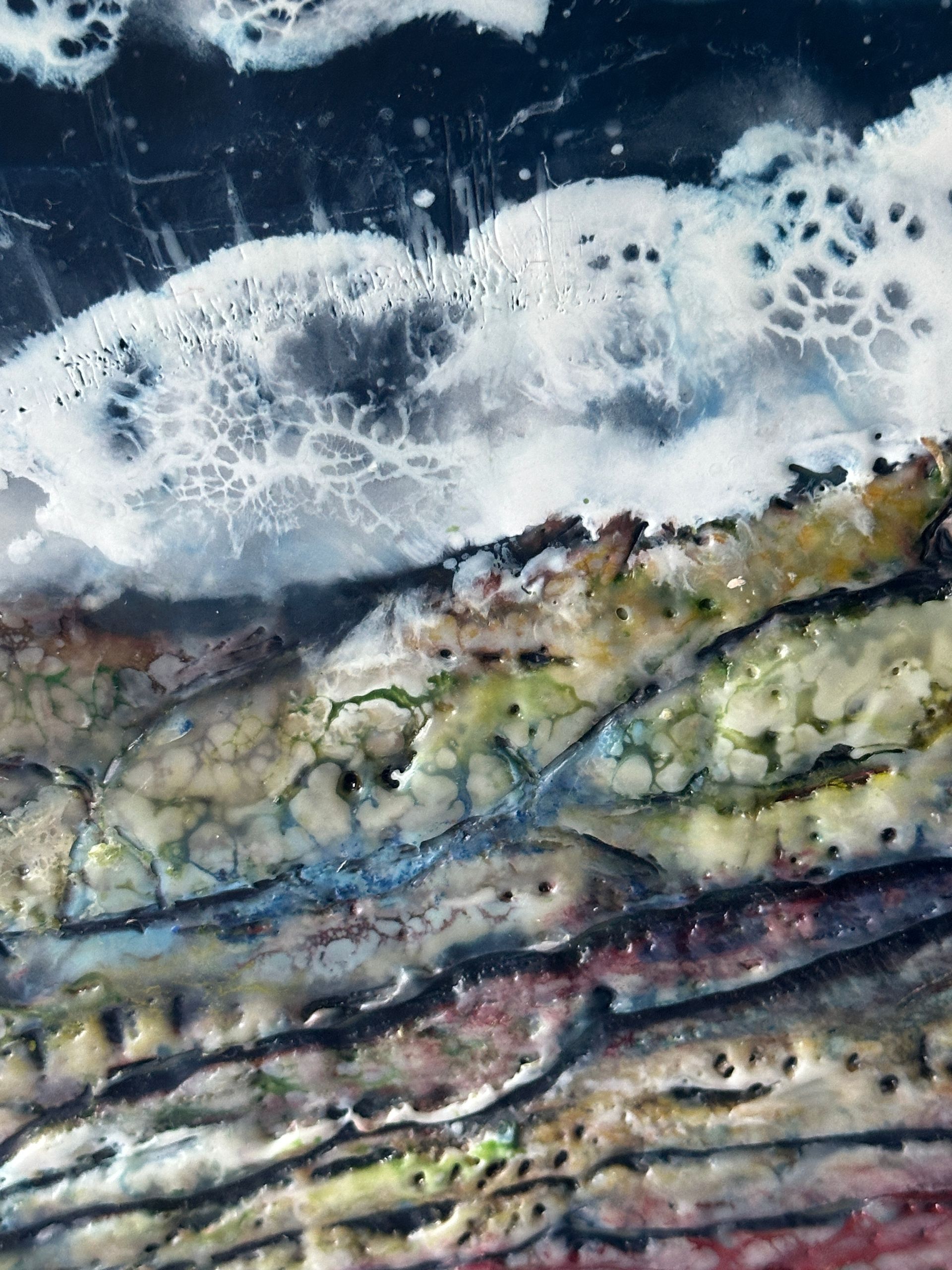 A painting of waves crashing on a rocky shore
