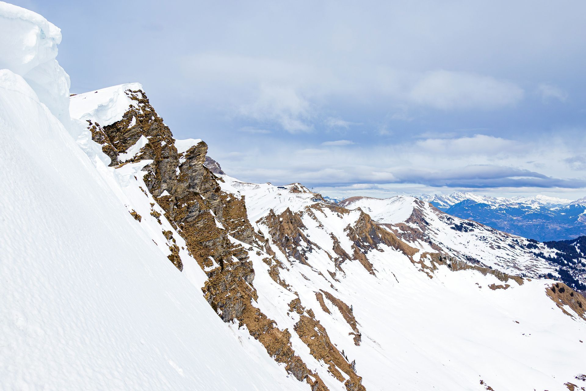 A snowy mountain with a blue sky in the background