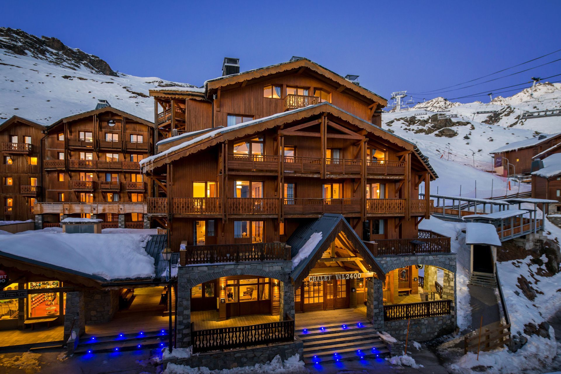 The Chalet Val 2400 building in Val Thorens lit up at night time