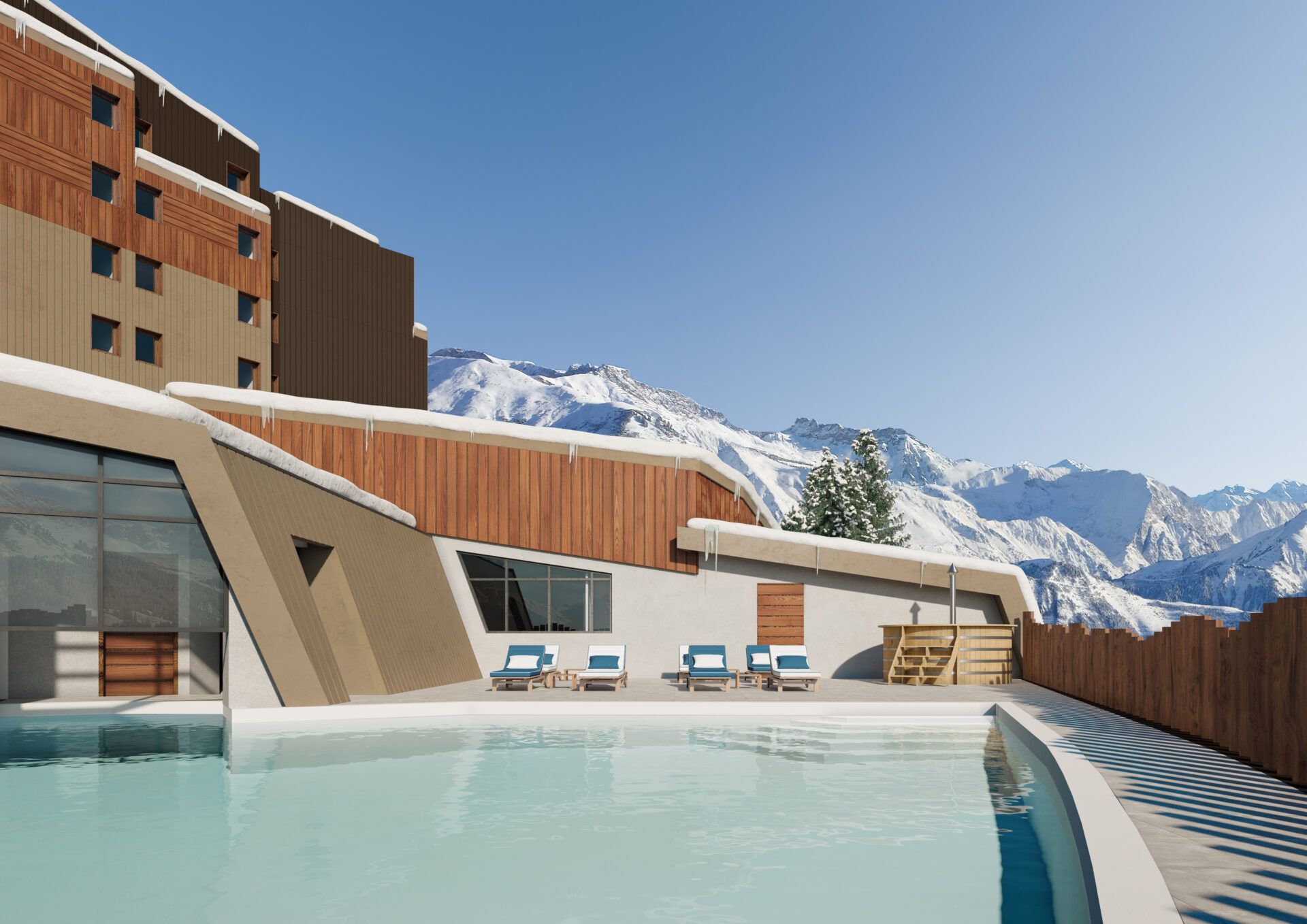 A swimming pool in front of a building with mountains in the background