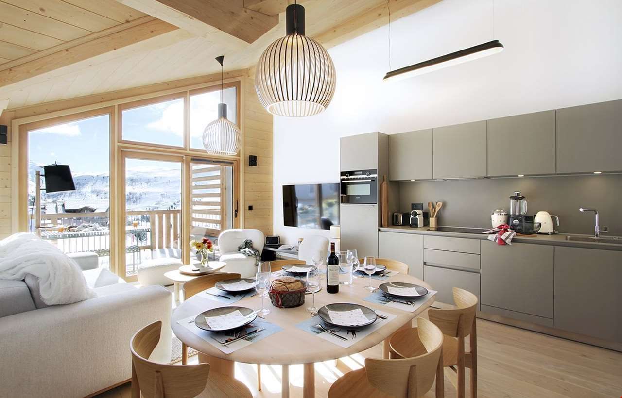 An image of one of the apartments at Prestige residence Phoenix B, with a living area with sofas, dining area and a kitchen