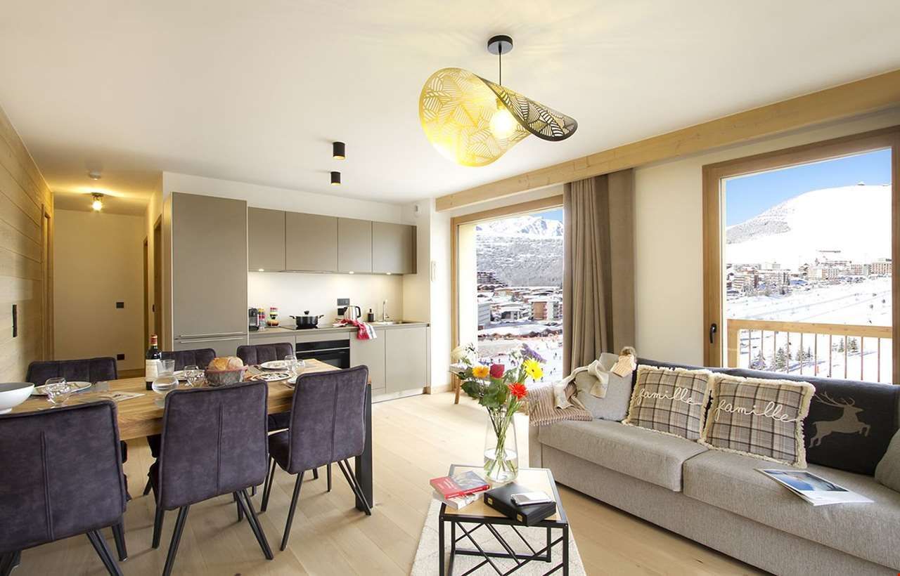 An image of one of the apartments at Prestige residence Phoenix B, with a living area with sofas, dining area and a kitchen