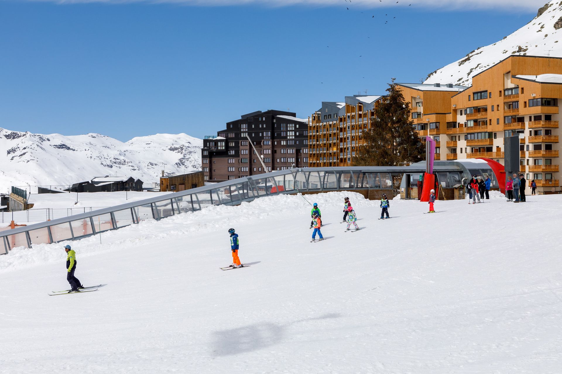 An image of children beginner skiers learning to ski on the nursery slopes