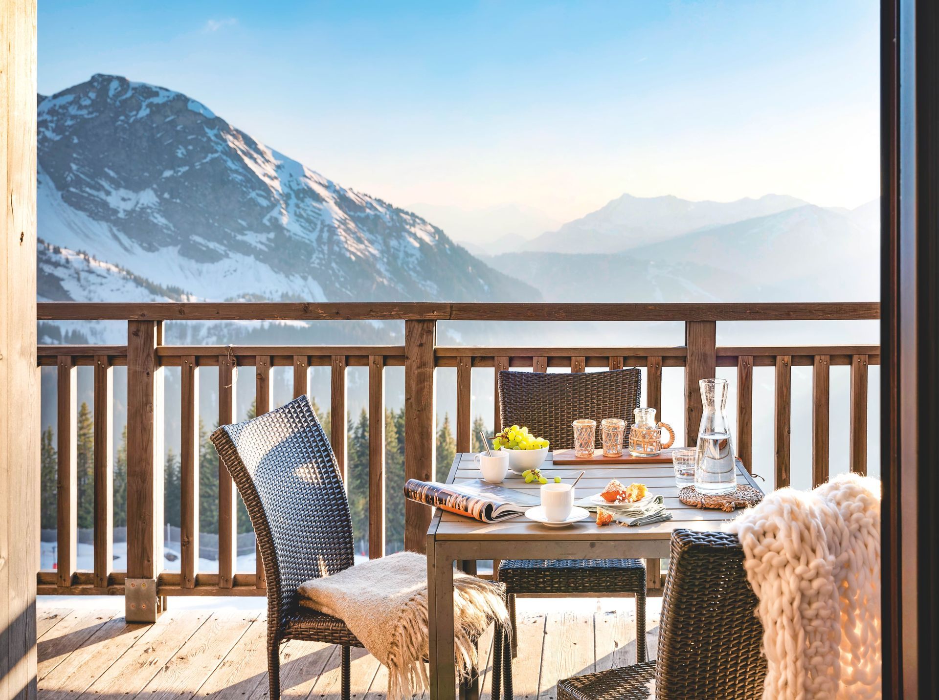 A balcony with a view of a snowy mountain range.