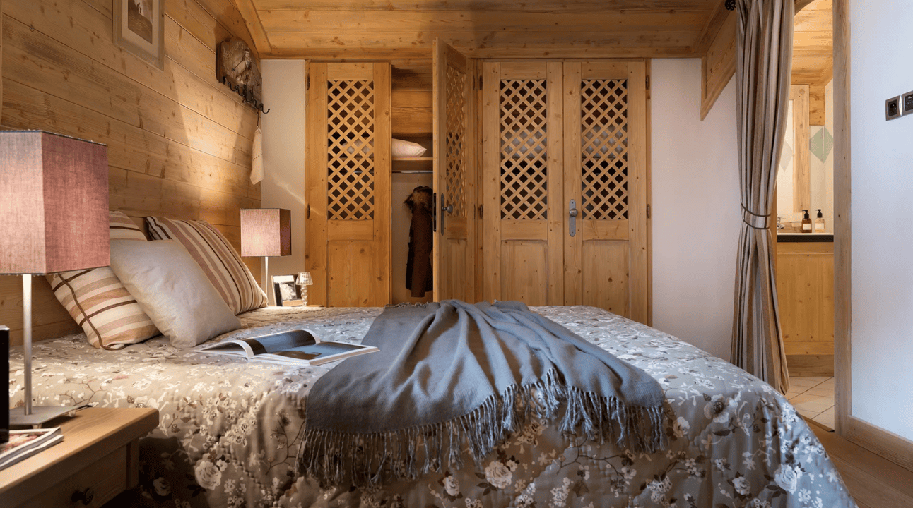 An image of a double bed in a luxerious looking bedroom at Les Fermes de Sainte Foy