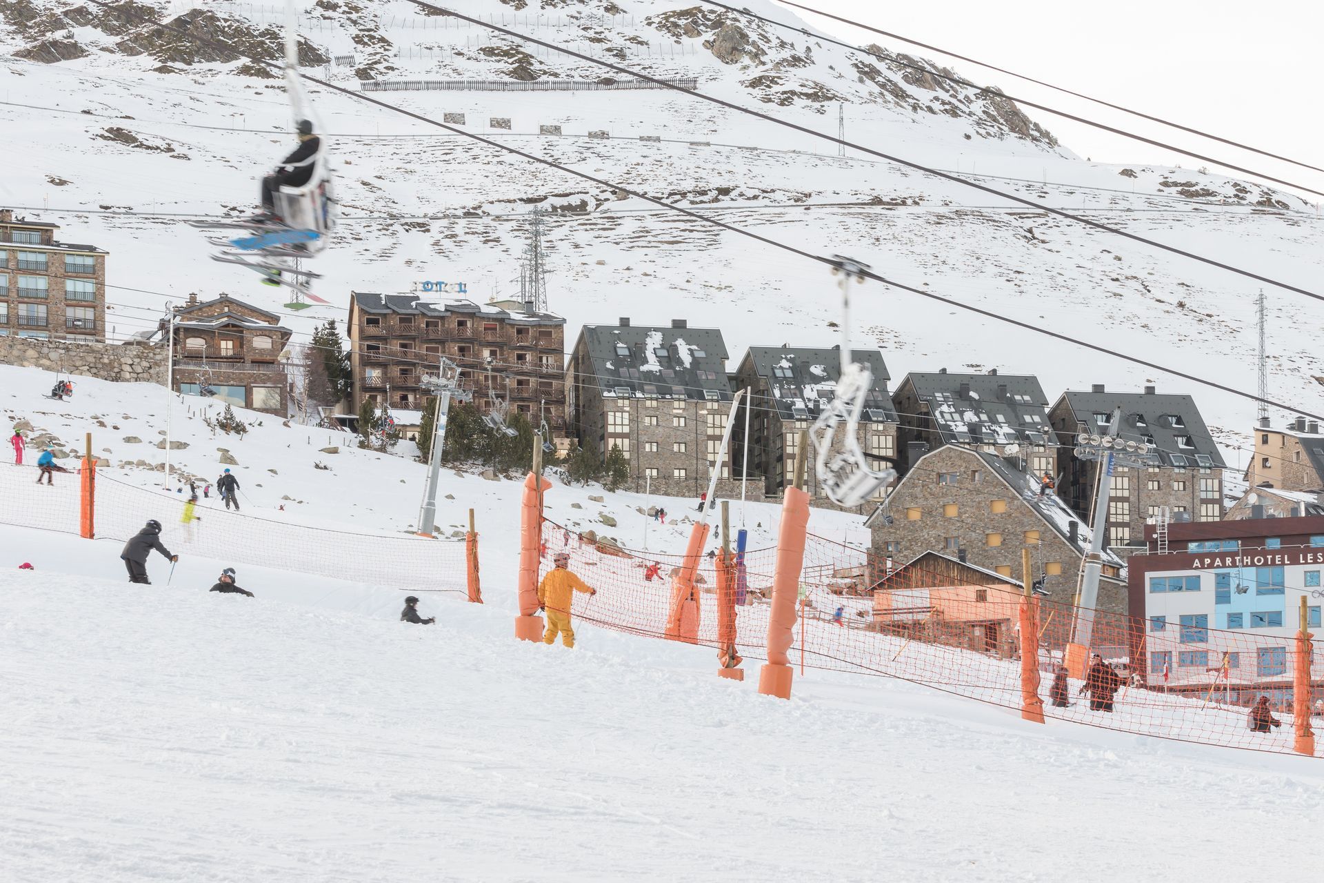 An image of a ski lift in the foreground and the hotels in the background in Pas de la Casa
