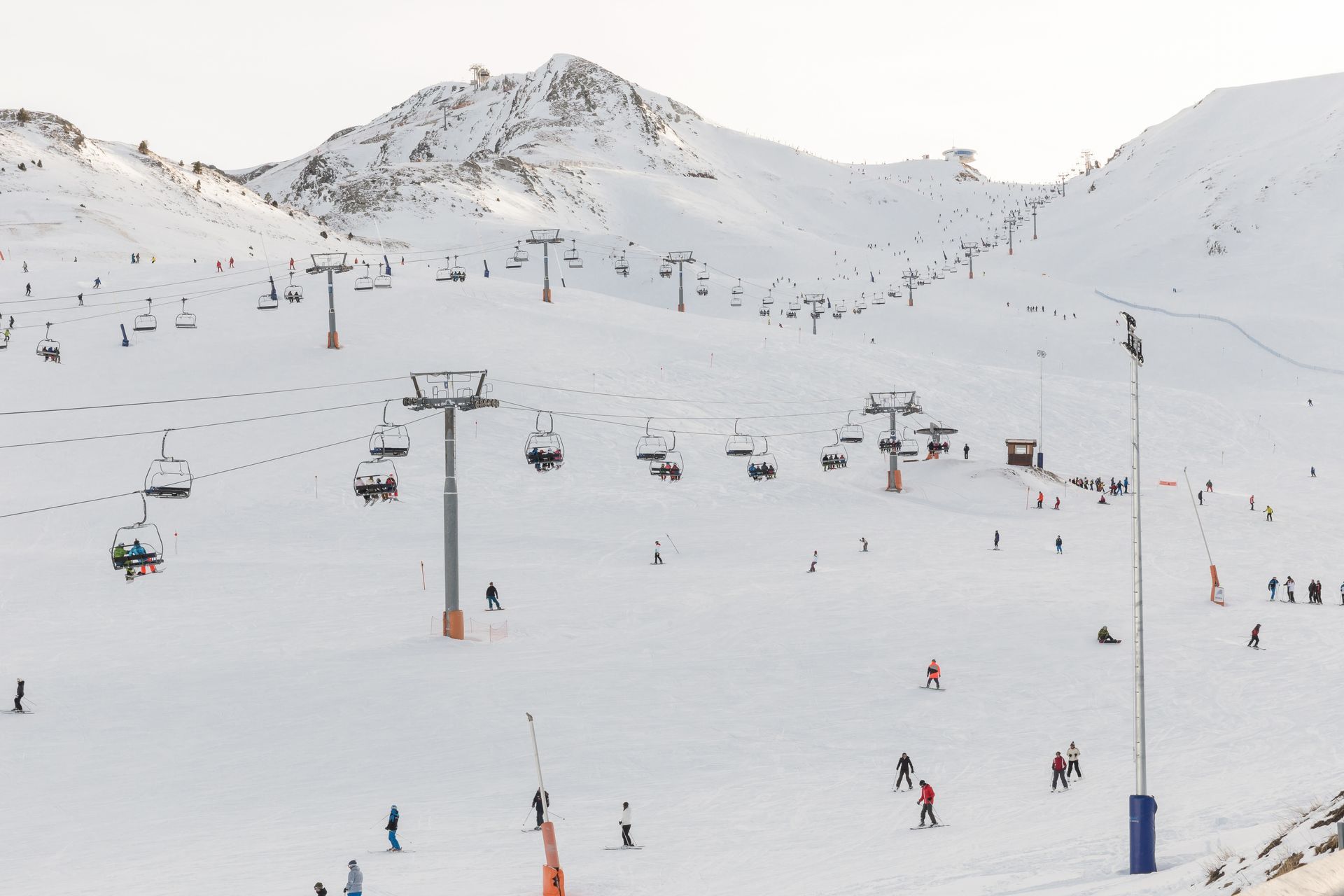 An image of the ski lifts and skiers on the pistes in the Grandvalira ski area